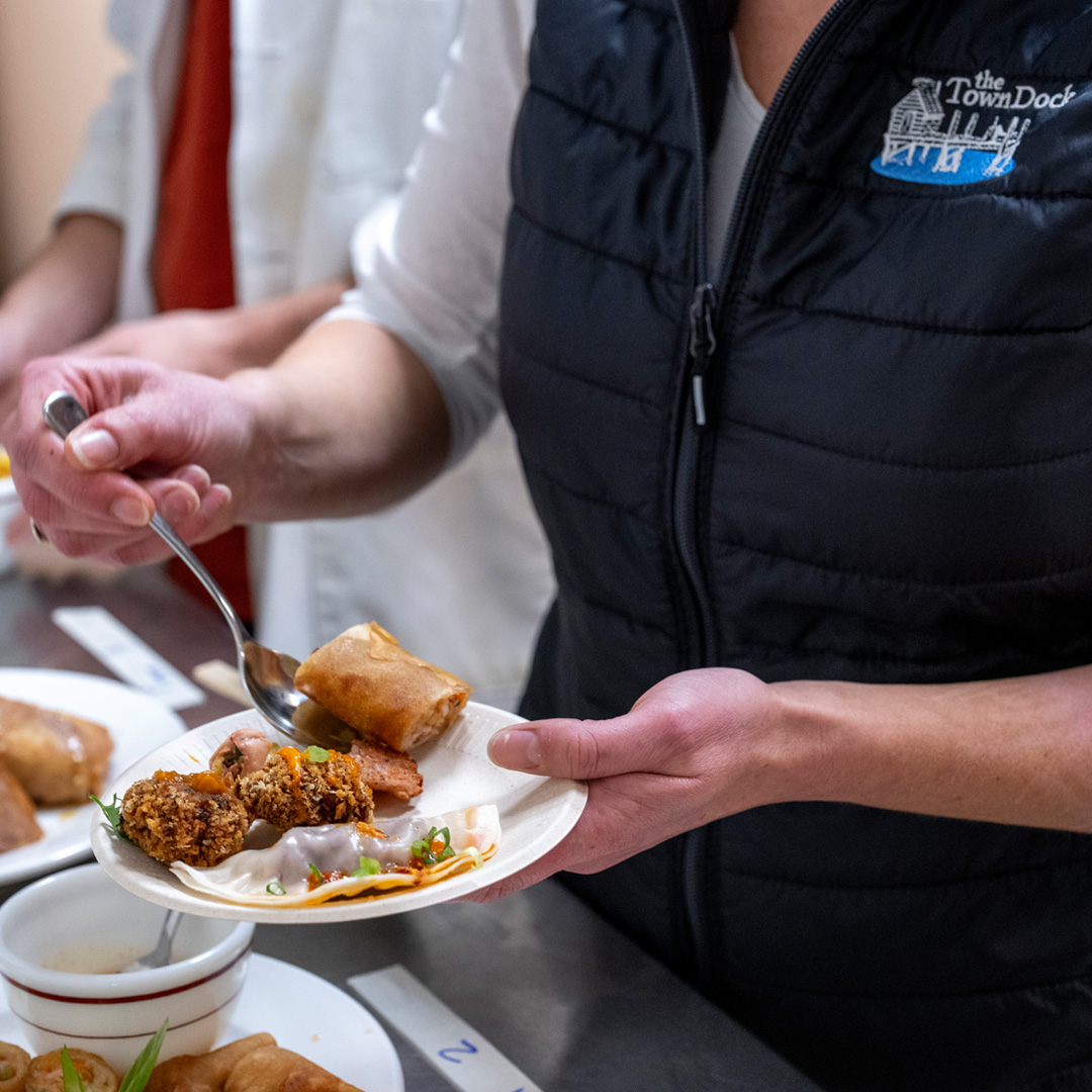 Doctor Brianna Hughes taste testing squid byproduct cuisine at UMaine.