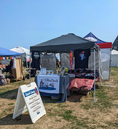 A photo of the vendor booth under a pop-up tent