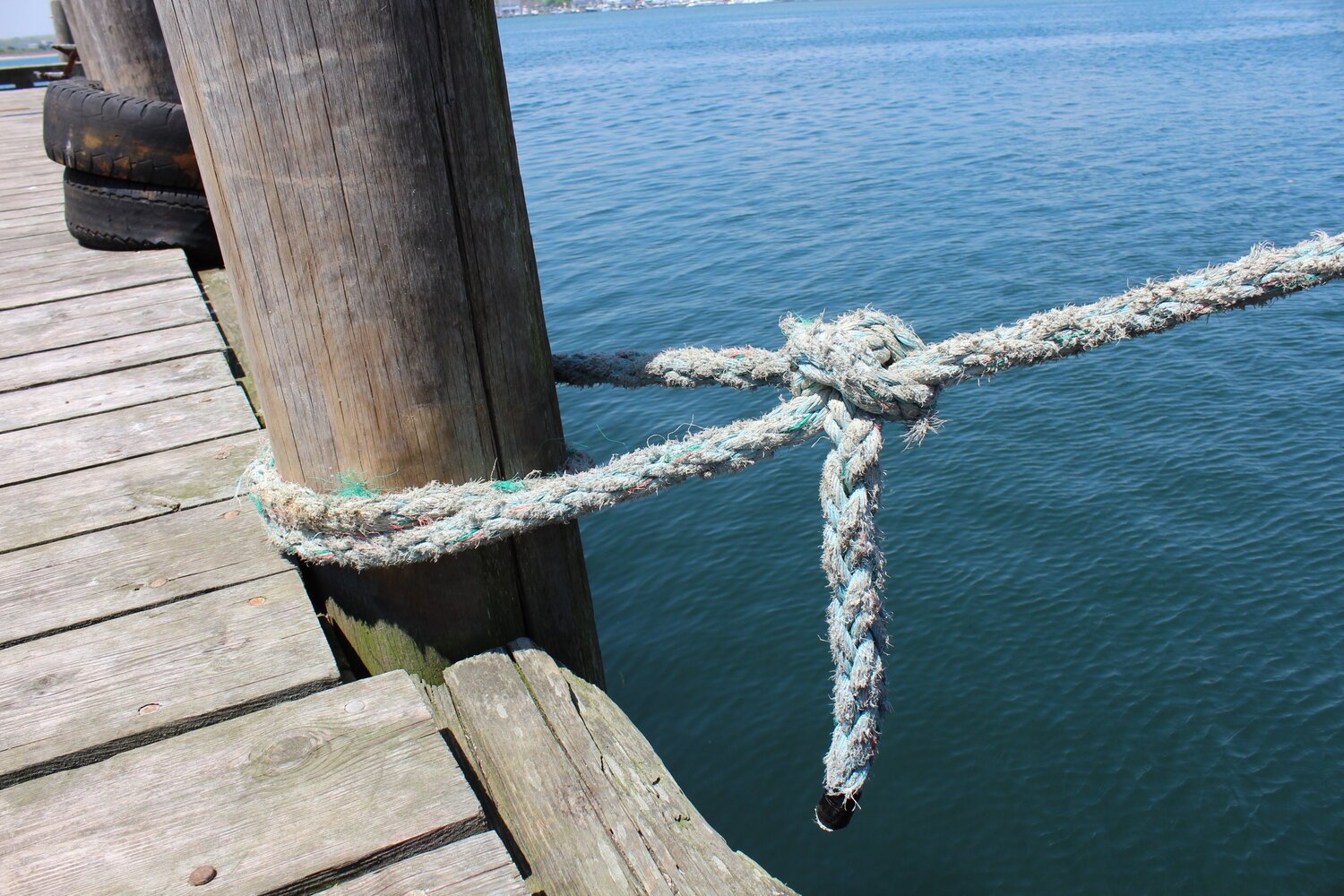 For more information, photo of a dock with a rope tied